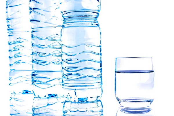 Plastic water bottles with a glass — Stock Photo, Image