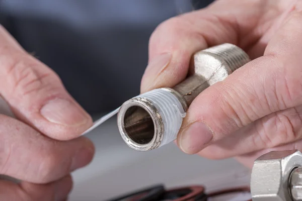 Plumber putting a teflon joint on a thread — Stock Photo, Image