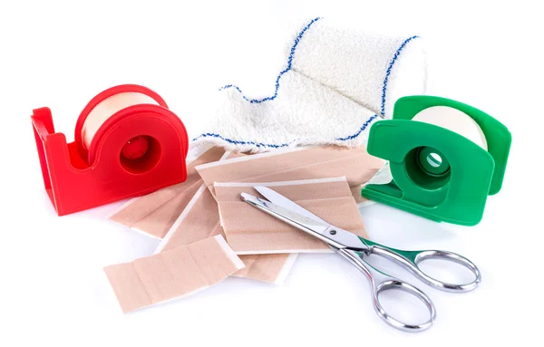 Sticking plasters and medical bandage with scissors — Stock Photo, Image