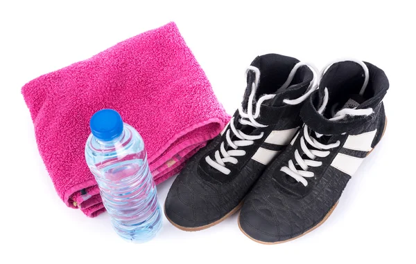 Sport shoes with terry towel and bottle of water — Stock Photo, Image