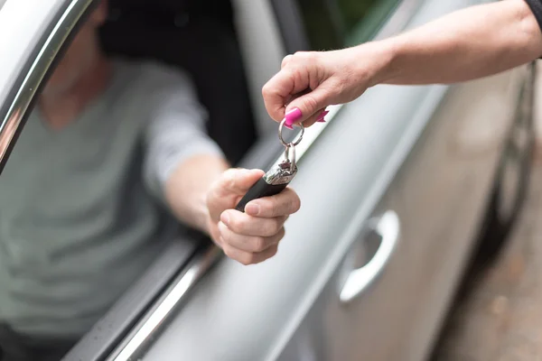 Hombre consiguiendo las llaves de su coche — Foto de Stock