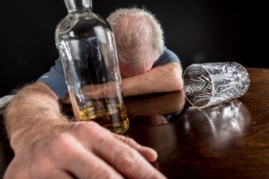 Drunk man slumped on table clipart