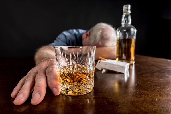 Drunk man slumped on table — Stock Photo, Image