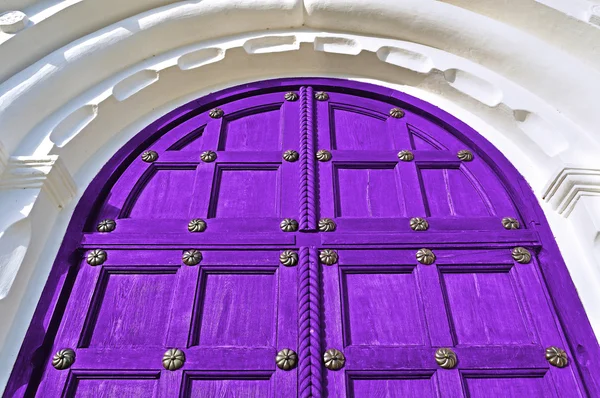Architecture detailed background - aged wooden door of purple color