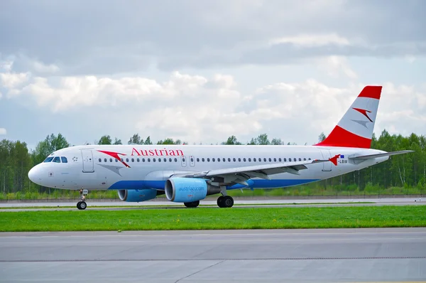 Austrian Airlines Airbus A320 airplane is riding on the runway after arrival at Pulkovo International airport in Saint-Petersburg, Russia