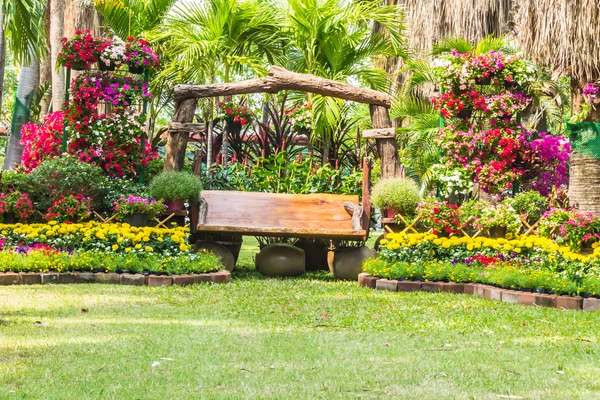 Wood chair in the flowers garden. — Stock Photo, Image