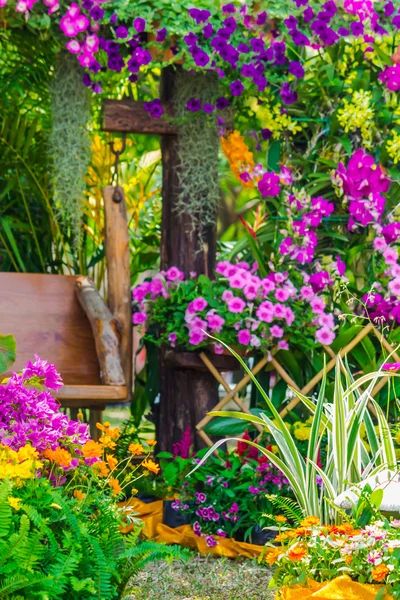 Wood chair in the flowers garden. — Stock Photo, Image