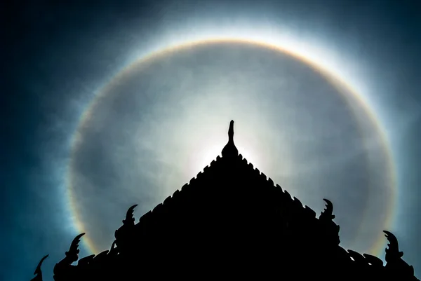 Double sun halo behind  the roof. — Stock Photo, Image