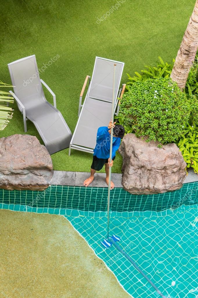 Swimming Pool Cleaner During His Work Stock Photo