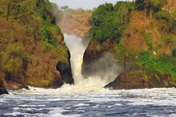 Murchison Falls or Kabalega Falls on the River Nile. Dense water foam in the foreground below the waterfalls on the Nile.