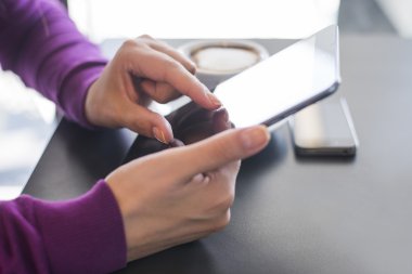 Dijital tablet ve cep telefonu olan kadın