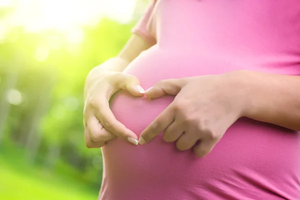 Pregnant woman relaxing in nature on a beautiful sunny day — Stock Photo, Image