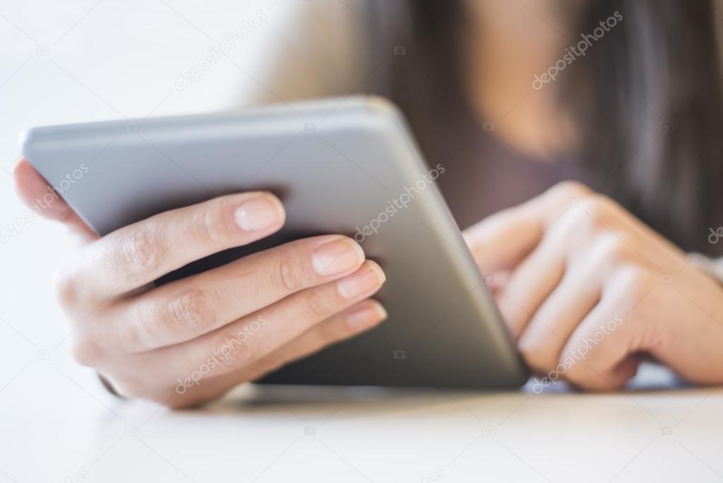 Woman reading an article on her tablet