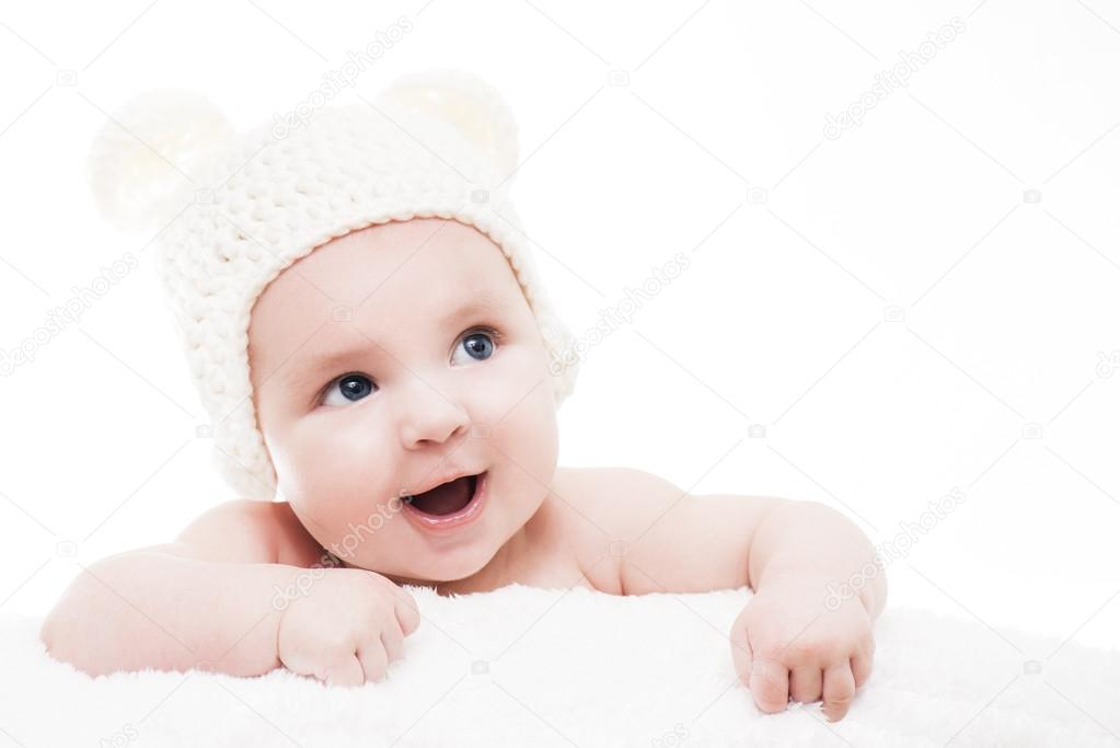 Laughing blue eyed baby with white hat