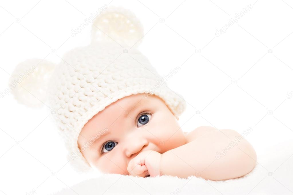 Baby wearing a knit hat with bear ears 