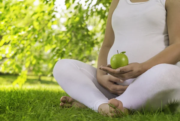 Pregnant woman holding digital tablet