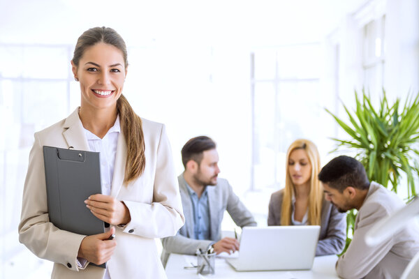 Successful businesswoman at the office leading a group