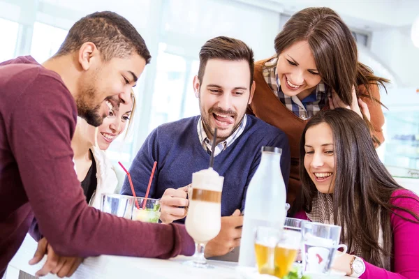 Happy young people having fun in a cafe