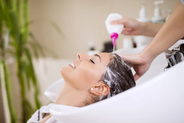 Hairdresser washing hair