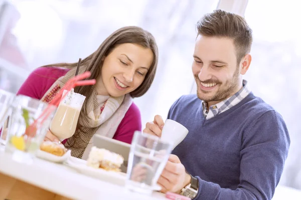 Young couple in love sitting in a cafe and communicating