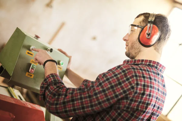 Carpenter with automatic circular saw — Stock Photo, Image