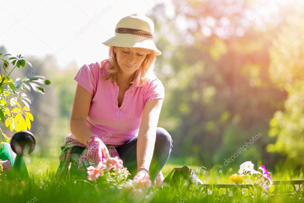 Gardener taking care of her plants in a garden