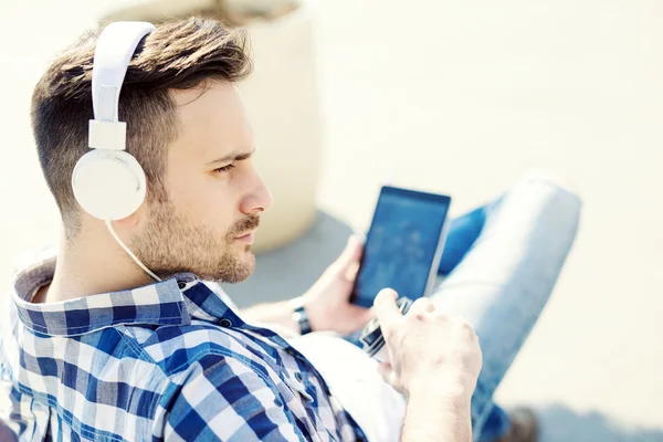 Young man listening music outdoors