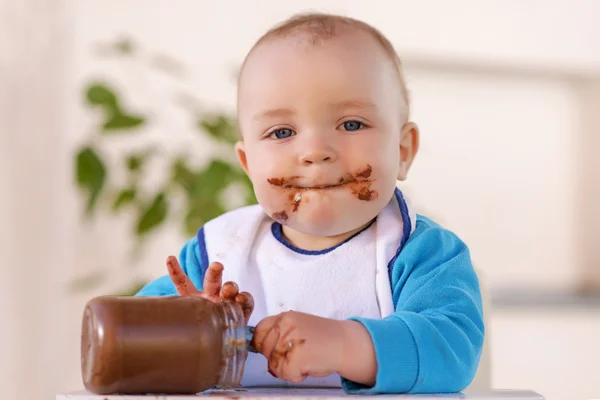 Мальчик ест шоколадный крем — стоковое фото