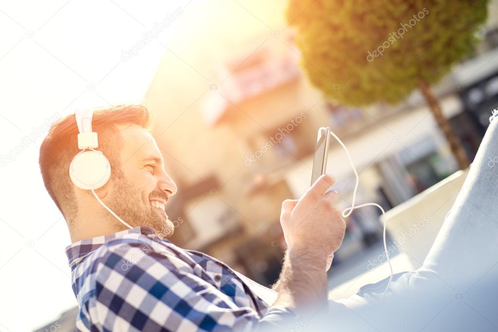 Young man with headphones enjoying the music