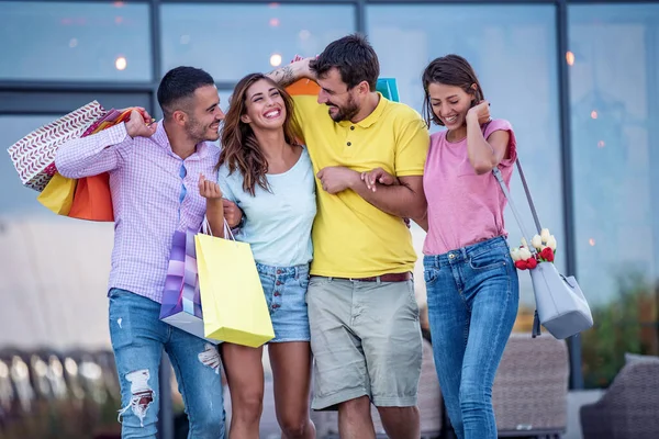 Happy group of friends with shopping bags in the city.Sale, shopping, tourism and happy people concept.