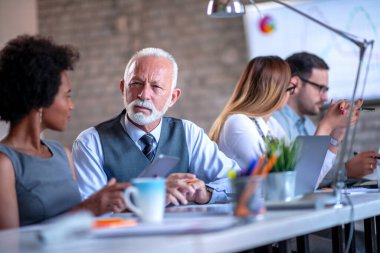 Modern ofiste birlikte çalışan bir grup iş adamı..