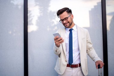 İş seyahati. İşe gidiyor ve cep telefonu kullanıyor..