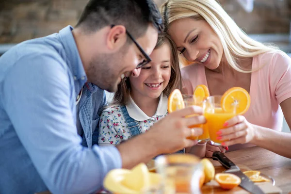 Happy Family Mother Father Daughter Drinking Juice Home — Stock Photo, Image