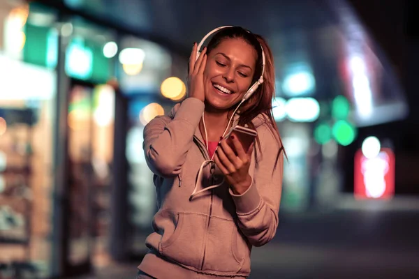 Young fitness woman jogging at night in the city. Fitness,people and workout concept.