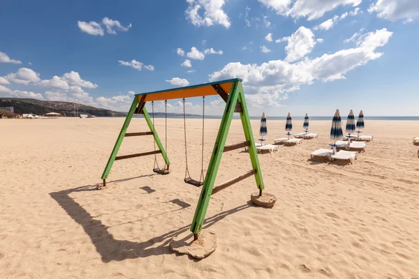 Playground swing on the beach — Stock Photo, Image