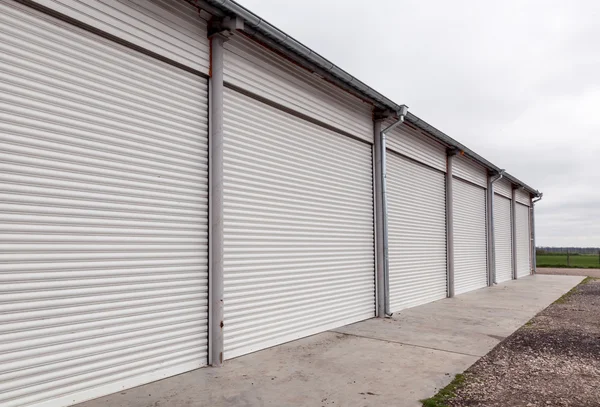 Storage units with roller shutter doors in industrial area — Stock Photo, Image