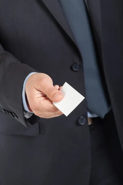 Business man handing a blank business card — Stock Photo, Image