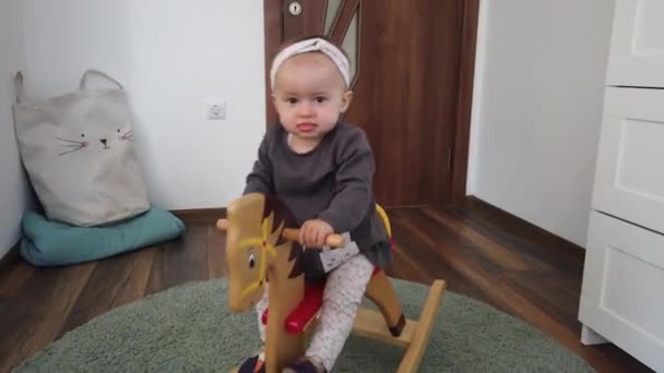 Happy Baby Girl Playing Wooden Rocking Horse Childhood Game Home — Stock Video