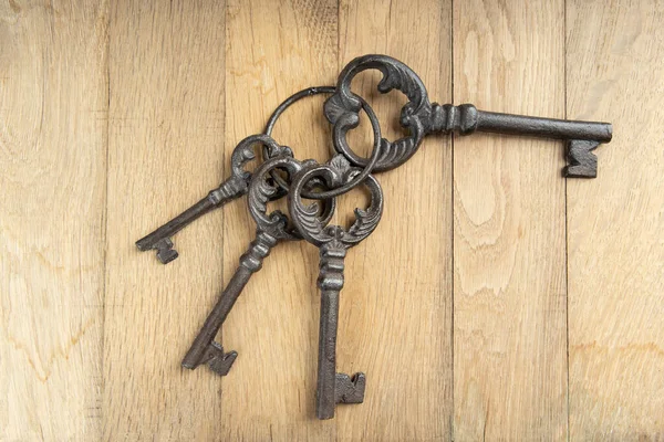 Bunch of old keys on wooden background