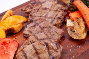 Tahtada ızgara biftek ve sebze.