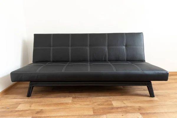 Modern Black Leather Convertible Sofa Bed Wooden Floor Empty Waiting — Stock Photo, Image