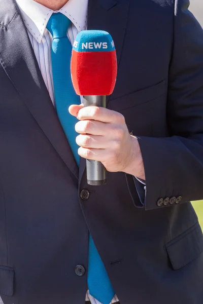 News journalist with microphone reporting — Stock Photo, Image