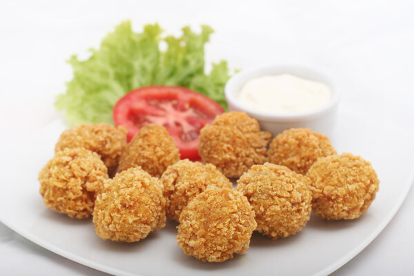 Fried cheese croquettes with sauce