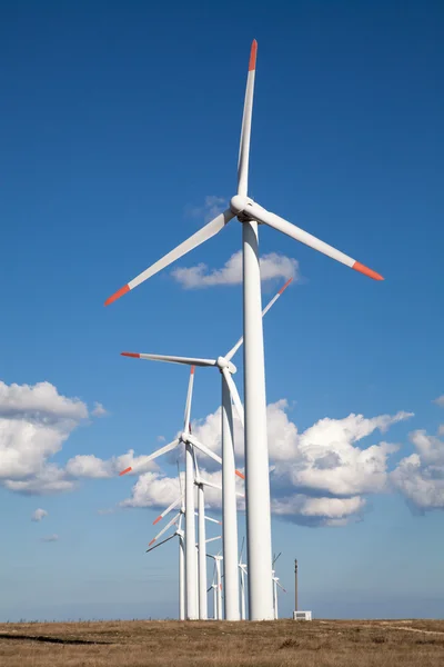 Wind turbine farm over the blue clouded sky — Stock Photo, Image