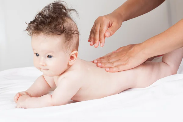 Mother is massaging her baby — Stock Photo, Image