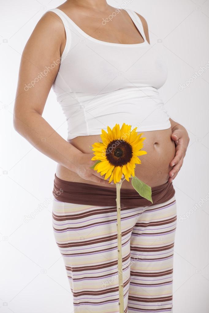 Pregnant woman holding a sunflower — Stock Photo © dechevm 54480709