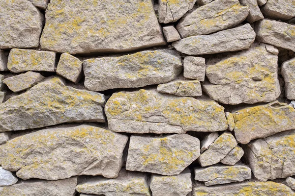 Detalhe de perto de uma parede de pedra velha — Fotografia de Stock