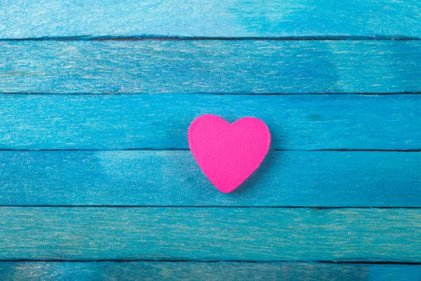 Decorative pink heart on blue wooden background — Stock Photo, Image