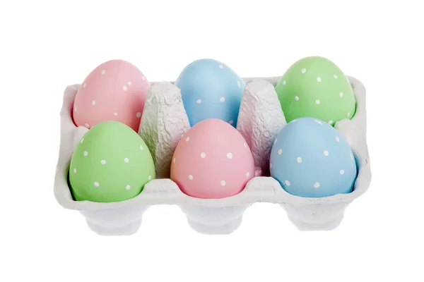 Pastel colored easter eggs in cardboard, isolated — Stock Photo, Image