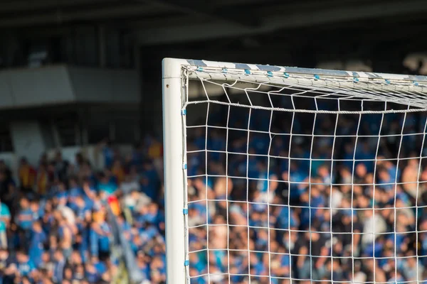 Goal post with soccer fans in the background — Stok Foto